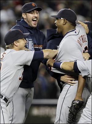 Justin Verlander, center, celebrates the Tigers' ALDS win over the New York Yankees with Jose Valverde, right and Andy Dirks, left.