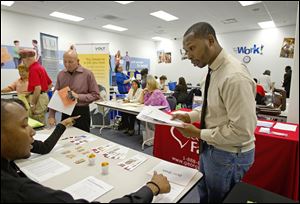 Job seekers attend a career fair at a Goodwiill store Tuesday, Oct. 4, 2011 in Atlanta. The number of people who applied for unemployment benefits rose slightly, a sign that the job market remains weak.