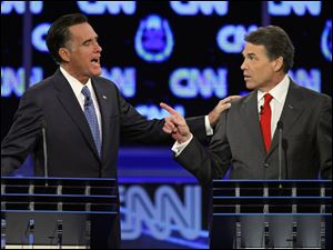 Republican presidential candidates former Massachusetts Gov. Mitt Romney, left, and Texas Gov. Rick Perry square off during a Republican presidential debate Tuesday in Las Vegas. 