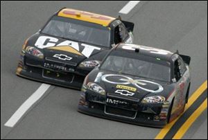 Clint Bowyer, right, passes Jeff Burton in Turn 4 on the final lap during at Talladega Superspeedway.