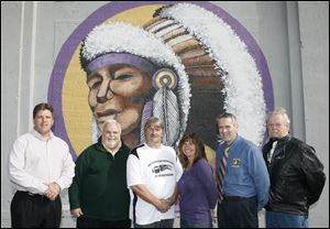 From left, Ed Langlois of Poggemeyer Design Group; Hugh Grefe, senior executive director of LISC; Mike Smith, president of the East Toledo Junior Football League; Cristina Lorton, Waite High School athletic director, David Yenrick, Waite principal, and Roger Dodsworth of the East Toledo Family Center, gather at Jack Mollenkopf Stadium.