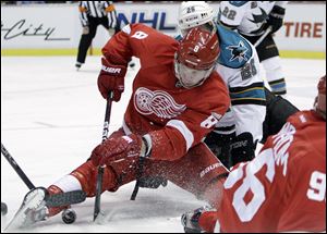 Detroit Red Wings left wing Justin Abdelkader (8) and San Jose Sharks center Michal Handzus (26), of Slovakia, battle for the puck during the second period of an NHL hockey game in Detroit, Friday.