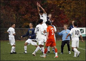 St. John's Jesuit High School players celebrate their 2-1 win over Sylvania Southview High School at Southview High School in the District Soccer Championships, Saturday.