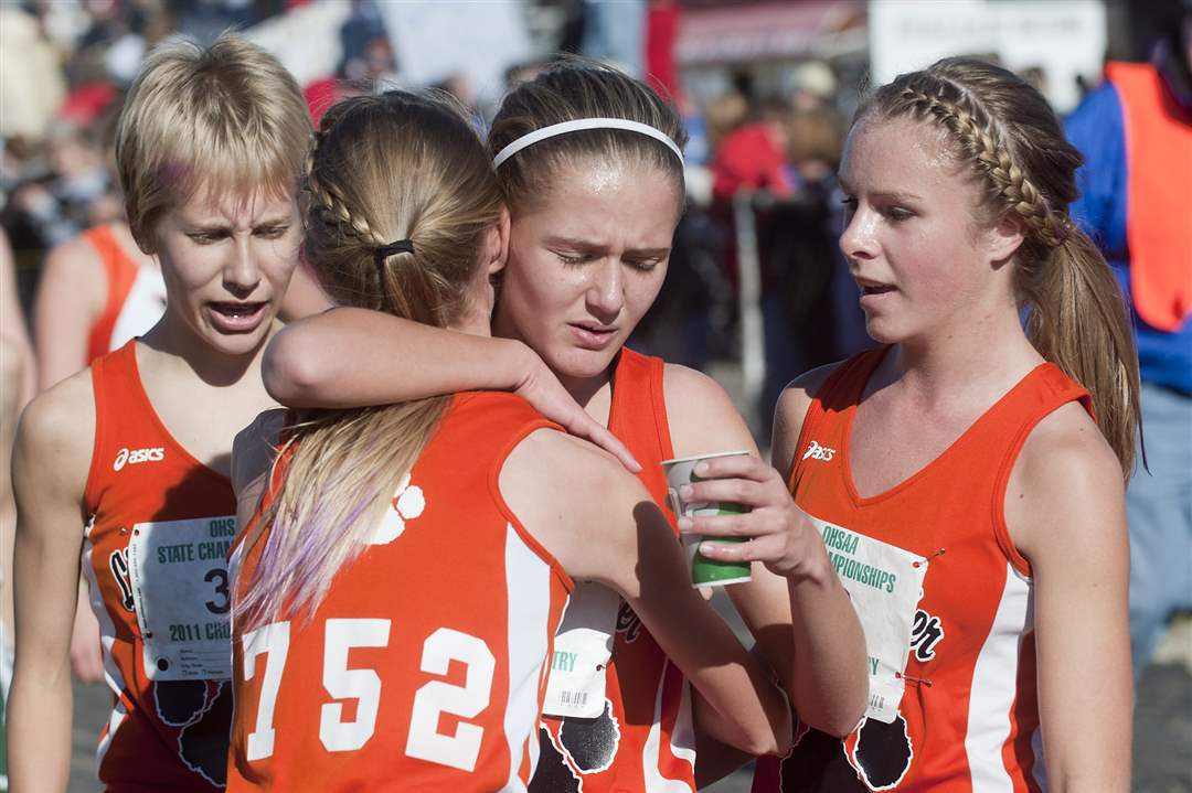 Liberty-Center-teammates-Kelly-Haubert-from-left-Paige-Chamberlain-Brittany-Atkinson-and-Chelsea-Knapp-huddle-up