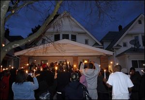 A crowd gathers outside the East Weber Street home where Darnell Townsend-Tall was slain.