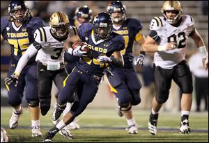 University of Toledo RB Adonis Thomas (24) runs the ball against  Western Michigan during the first quarter Tuesday, at the Glass Bowl in Toledo.