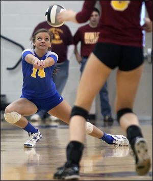 St. Ursula's Katie Felix (14) returns a serve against Avon Lake Wednesday during a Division I volleyball regional semifinal at Norwalk High School in Norwalk, Ohio.