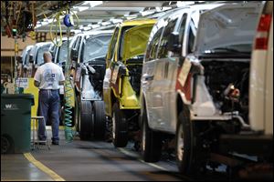 A General Motors employee works on a van assembly line at GM's plant in Wentzville, Mo. 