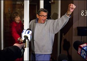 Penn State coach Joe Paterno and wife Sue address students from the front porch of their home Wednesday night. The students yelled, 