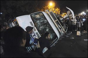 Penn State students flip a television news van during a riot Wednesday.