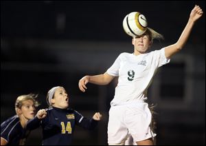 Archbold's Lauren Kindinger (14) reacts as Shaker Heights Laurel's Jill Dayneka (9) hits the ball with her head during a Girls Division III state semifinal soccer match in Clyde, Ohio. Laurel defeated Archbold 1-0.