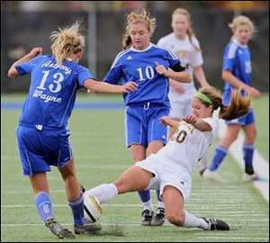 Sylvania Northview's Brooke Snead (20) kicks the ball past  Anthony Wayne's Aubrie Kreft (13) and Ali Mortemore (10) during the Division I district girls soccer final at Springfield High School in Holland, Ohio.