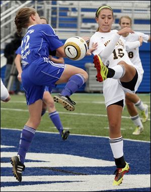 Sylvania Northview's Erin Bishop (15) takes a shot at the goal as Anthony Wayne's Hayley Wagner (22) defends.