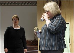 Carrie Arndt, of 'AWAKE' discusses how cans and bottles can be used by teens to do drugs as Kathy Schnapp, left, of 'AWAKE' looks on.