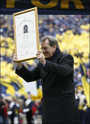 Former Michigan coach Lloyd Carr is honored before Saturday's game.