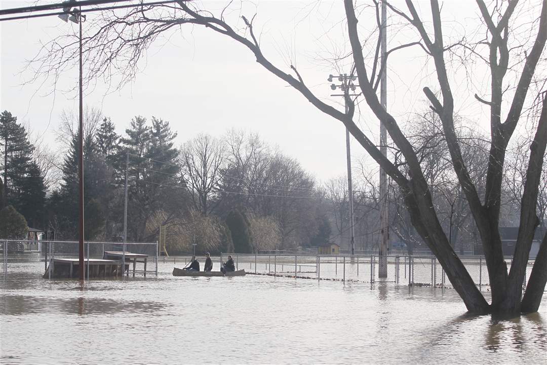 people-canoe-in-flooded-waters