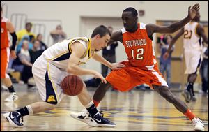 Whitmer's Tyler Klem (12) drives past Sylvania Southview's Chris Johnson (12).