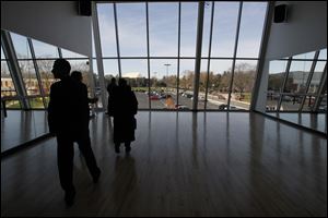 The windows of the Wolfe Center's dance classroom are reflected in mirrors on both sides of the room.