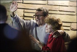 Joe Paterno and his wife, Susan, stand on their porch to thank supporters gathered outside their home.