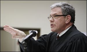 Judge Gene Zmuda makes a point during a hearing on the sale of Tony Packo's restaurants to Bob Bennett, in Lucas County Common Pleas Court Thursday.