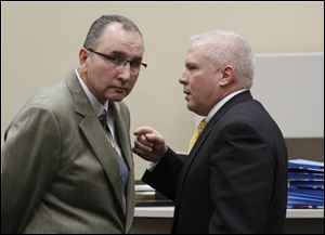 Robin Horvath, left, with attorney Troy Moore, said the sale of the chain to Bob Bennett has been complicated by another lawsuit and the indictment of Tony Packo III and controller Cathleen Dooley.