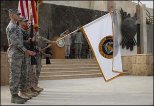 During a ceremony in Baghdad, the flag used by U.S. forces in Iraq is lowered before being encased. The ceremony marked the official end of the U.S. military mission in that country.