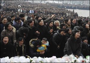 Pyongyang citizens grieve Wednesday as they visit a portrait of late North Korean leader Kim Jong Il on display in the plaza of the Pyongyang Indoor Stadium in Pyongyang, North Korea.