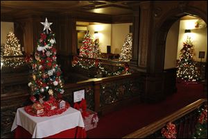 The Toledo Club Employees / Toledo Northwest Ohio Food Bank tree, foreground, is among several decorated trees in the Holiday Parade of Trees exhibit at the Toledo Club.