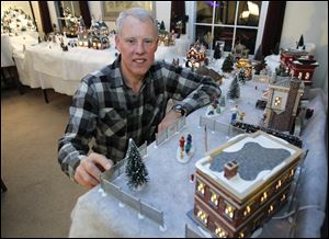 Kent Koepfer removes the living room furniture to make way for his village over the holidays.