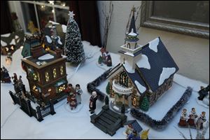 Kent Koepfer's Snow Village represents the Sylvania of his youth. The church is to represent St. Joseph Catholic Church, where he and his wife, Marilyn, were married.