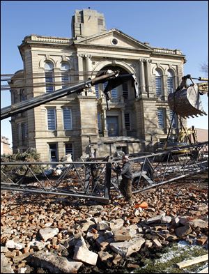 Workers assemble a crane in preparation for demolition of The Seneca County Courthouse.