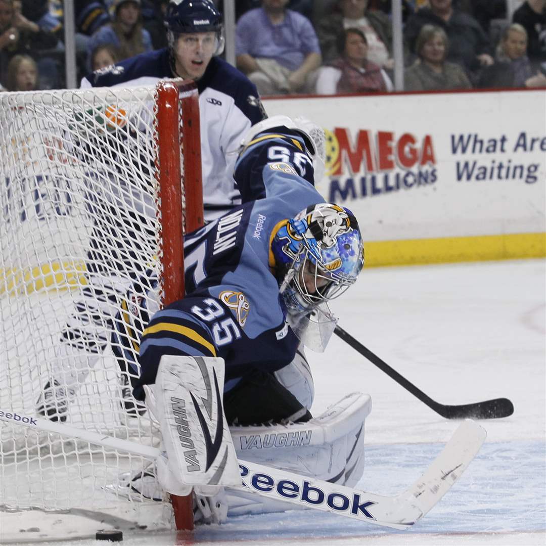 Walleye-goalie-Rob-Nolan-covers-a-shot-by-the-Greenville-Road-Warriors