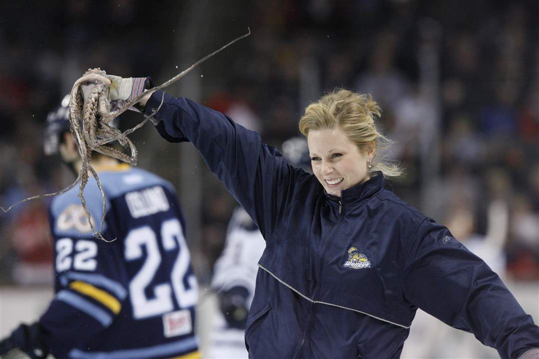 Toledo-Walleye-ice-crew-member-Kate-Schmoekel-carries-away-an-octopus