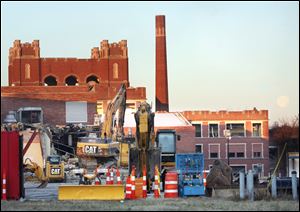 Razing of Libbey High School on Western Avenue continues Tuesday morning.