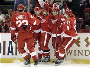 Detroit Red Wings' Henrik Zetterberg (40), of Sweden,, center celebrates his goal with defenseman Brad Stuart (23), from left, defenseman Niklas Kronwall (55), of Sweden, Zetterberg, wing Jiri Hudler (26), of the Czech Republic,  and center Valtteri Filppula (51), of Finland,  against the Buffalo Sabres in the first period of an NHL hockey game in Detroit.