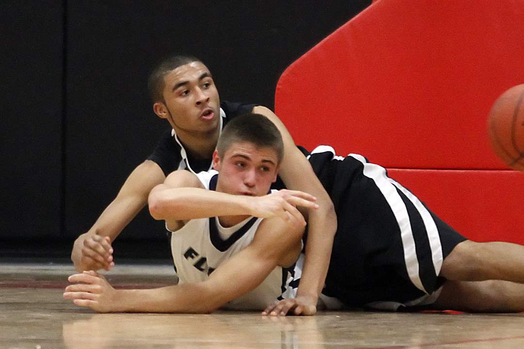 Lake-s-Josh-Tantari-battles-for-a-loose-ball-with-Fostoria-s-Xavier-Ragin