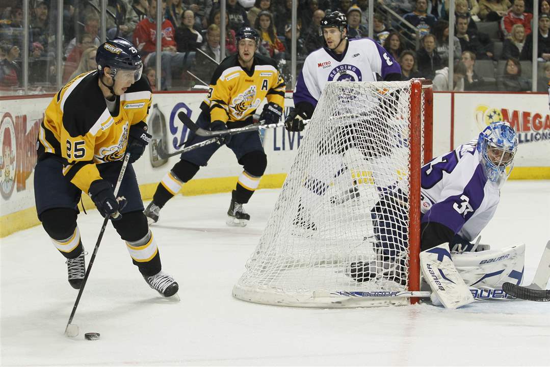 Toledo-Walleye-player-Adam-Estoclet-brings-the-puck-out-from-behind-the-net