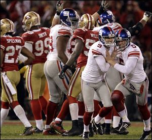 Giants kicker Lawrence Tynes (9) celebrates with holder Steve Weatherford (5) after kicking the game-winning field goal during overtime of the NFC Championship game against the San Francisco 49ers.