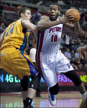 Detroit Pistons' Greg Monroe (10) drives to the basket against New Orleans Hornets' Jason Smith (14) in the fourth quarter of an NBA basketball game Saturday.