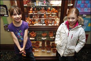 Sylvania Central Elementary first graders Kaylee Skinkiss, 6, and Quinn Rinke, 7, stand near their artwork that's displayed at the Heritage Museum in Sylvania.