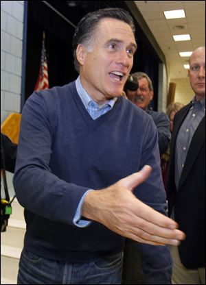 Republican presidential candidate Mitt Romney greets a supporter at an election caucus in Portland, Maine on Saturday.