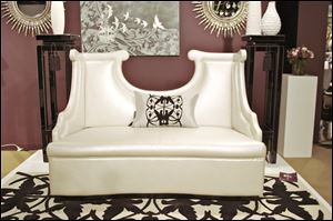 A high sculpted-back settee in pearl finish from Priscilla Presley's home collection.