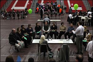 Jacob Vugrinac, of Players Services, at right, interviews a group of job seekers during the Hollywood Casino Job Fair last month at Owens Community College in Perrysburg Township.