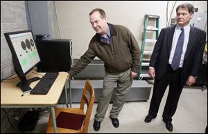 Left to right Dean E. Sandwisch, director of business affairs, and Michael E. Zalar, Oregon City Schools superintendent, in the wind turbine control room at Eisenhower Middle School in Oregon. Oregon City Schools'  wind turbines are up and running.