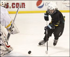 Jarod Van Hersett shoots during the first intermission of Friday's Walleye game. In honor of Cody Van Hersett, the Walleye gave tickets to his family and Clay teammates. 