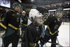 Jarod Van Hersett, 11, wears his brother Cody's No. 23 jersey in his honor as Clay High School player A.J. Burns, right, congratulates him for making a shootout goal during the first intermission of the Walleye game. Cody Van Hersett died in a January car crash. 