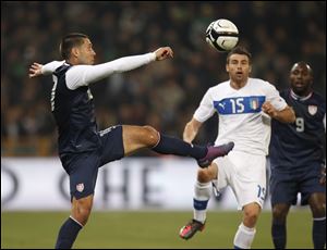 US forward Clint Dempsey, left, challenges for the ball with Italy's defender Andrea Barzagli during a friendly soccer match between Italy and USA, at the Genoa Luigi Ferraris stadium, Italy.