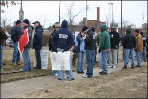 Toledo firefighters protest union concessions outside the city's Division of Environmental Services building Thursday.