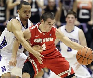 Ohio State's Aaron Craft controls the ball as Northwestern's Reggie Hearn defends. OSU needs to beat Michigan State to share the Big Ten title.