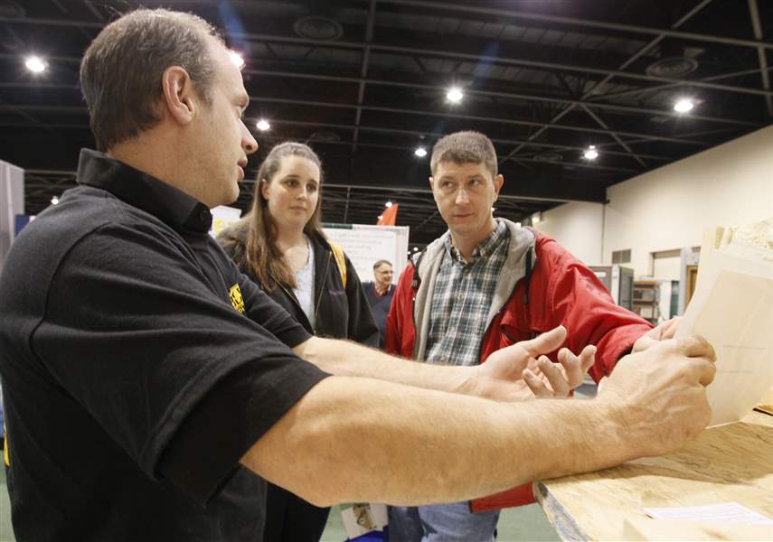 Dan-Schmitt-left-speaks-with-Mae-and-Tony-Dryer-of-Adrian-about-spray-foam-insulation